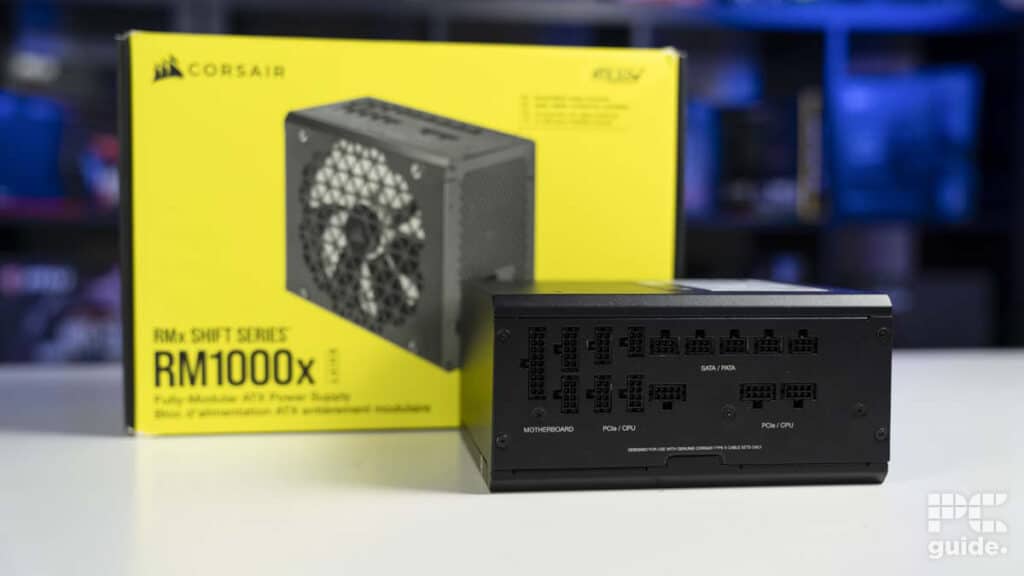 Corsair rm1000x fully modular power supply unit in front of its packaging box. Image by PCGuide