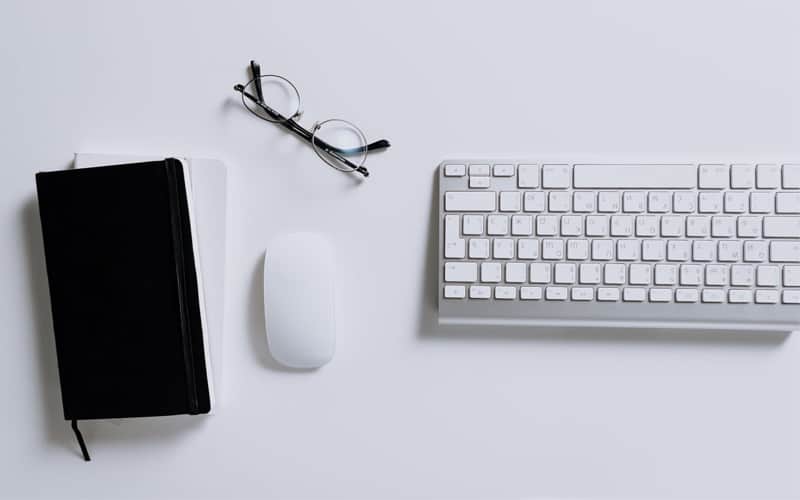 glasses keyboard mouse notepad