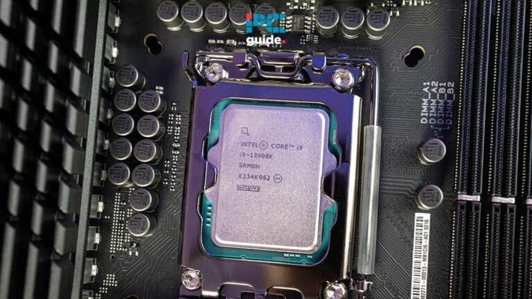 An Intel Core i9-13900K CPU installed in a motherboard socket, focusing on the detailed processor markings and CPU temperature. Image taken by PCguide.com