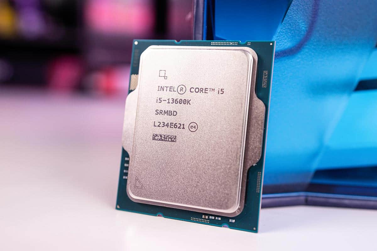 An Intel Core i5-13600K processor displayed in front of a blurred computer case.