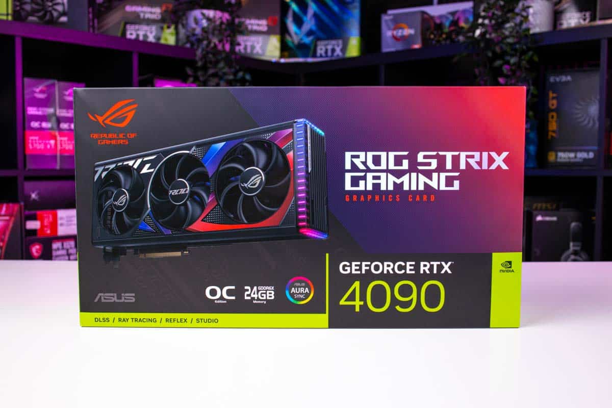 An Asus ROG Strix GeForce RTX 4090 graphics card box, one of the best workstation GPUs, on a desk with colorful lighting in the background.