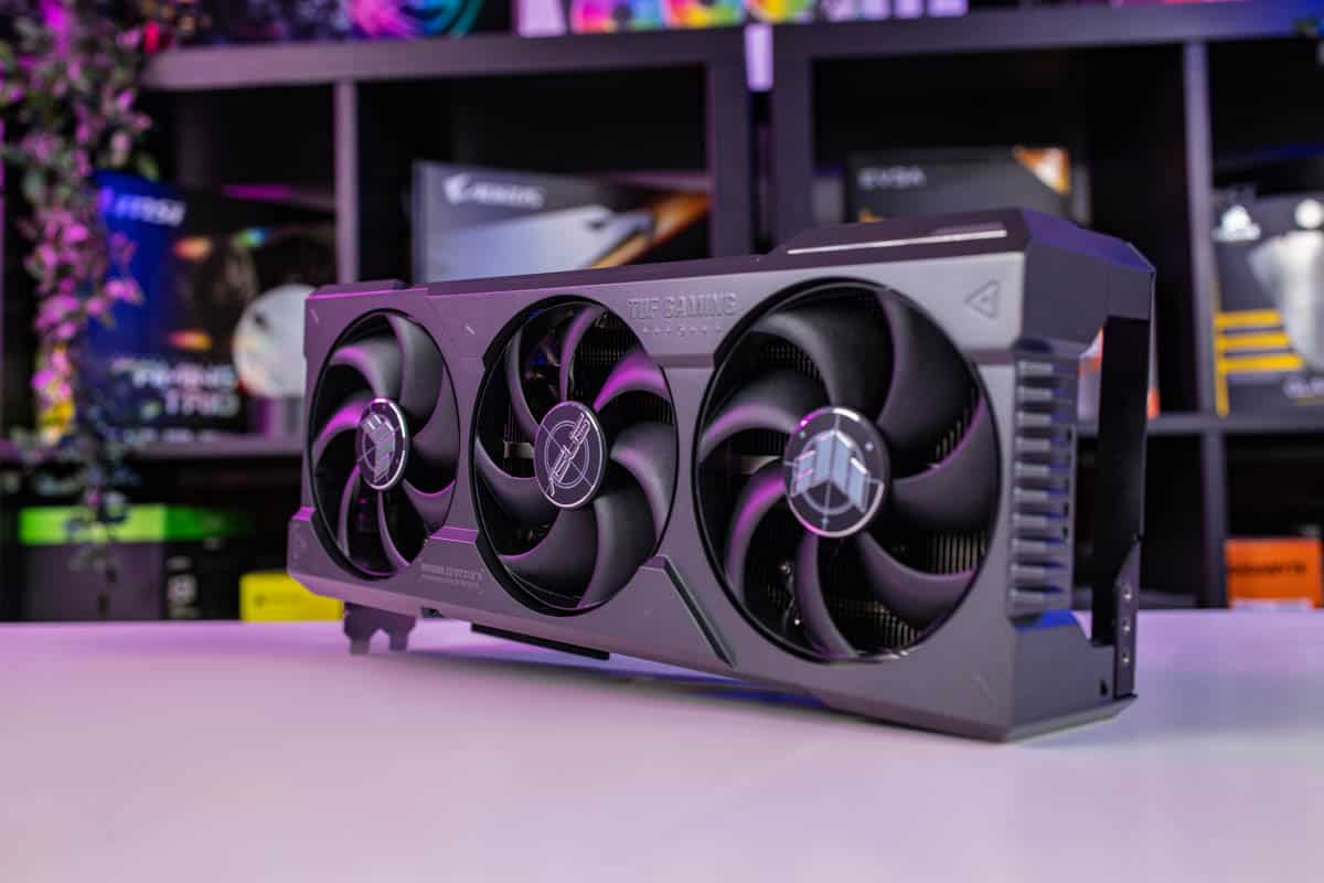High-end gaming graphics card, the RTX 4080, on a desk with rgb lighting in the background.