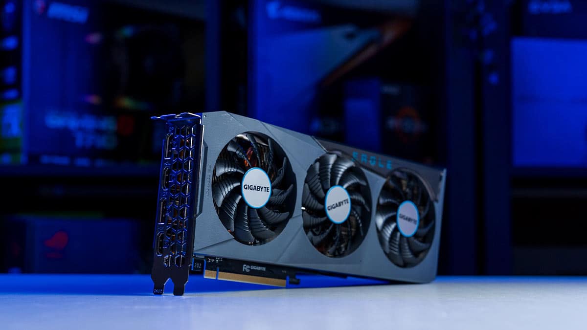 The Gigabyte RTX 4070 is displayed on a white desk with a blue LED light background.