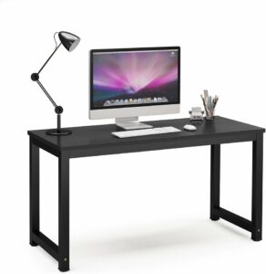 A Tribesigns 55" black computer desk with a monitor and lamp.