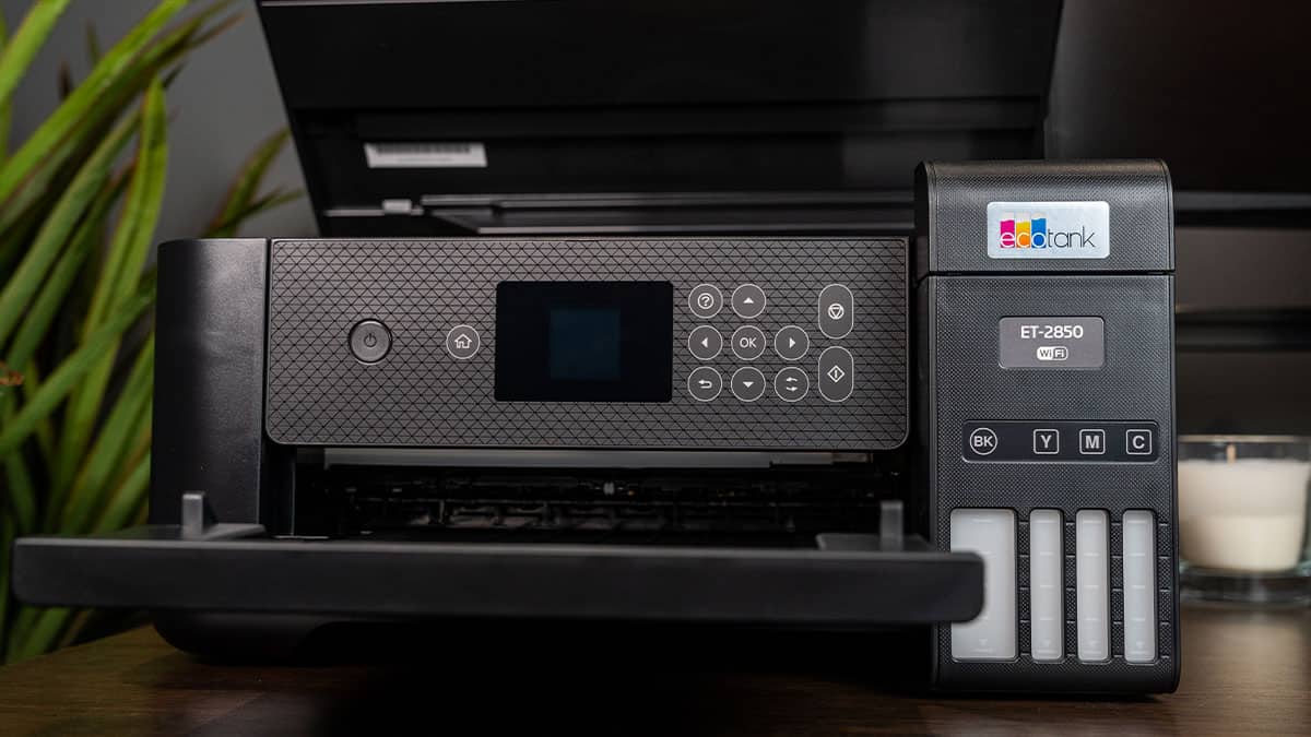 An Epson EcoTank ET-2550, one of the best printers for home, on a wooden desk with its ink levels visible on the front.