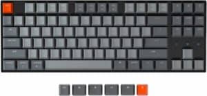 A Keychron K8 80% gray keyboard with orange keys.