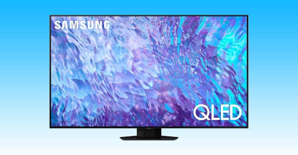 The Samsung QLED monitor is displayed on a vibrant blue background.
