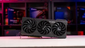 An Asus TUF Gaming RTX 4070 Super graphics card, recognized as the best GPU for New World, with triple fans, set against a colorful, RGB-lit computer hardware background.