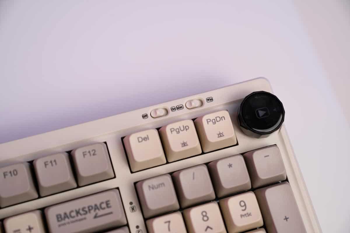 A close up of a retro-styled top-notch keyboard with a black button.