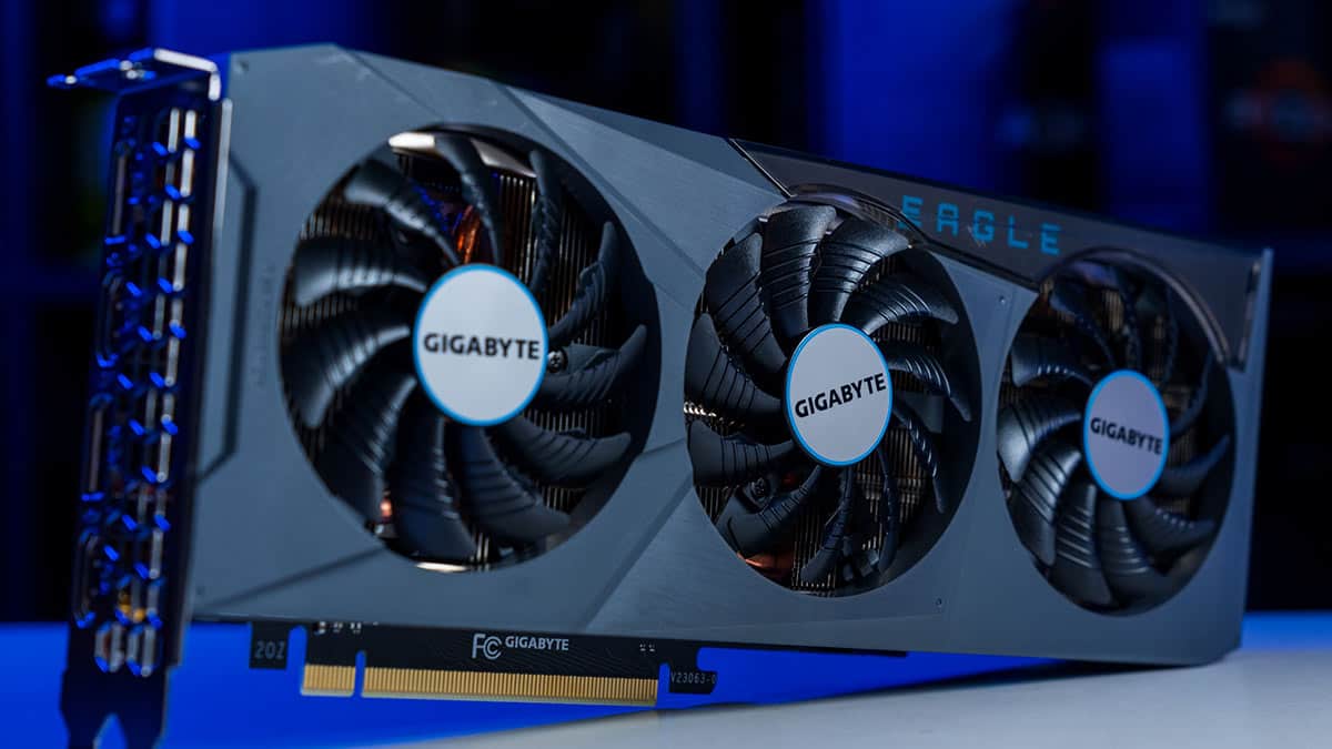 A Gigabyte GeForce RTX 4070 Eagle OC graphics card with triple fans illuminated by blue light.