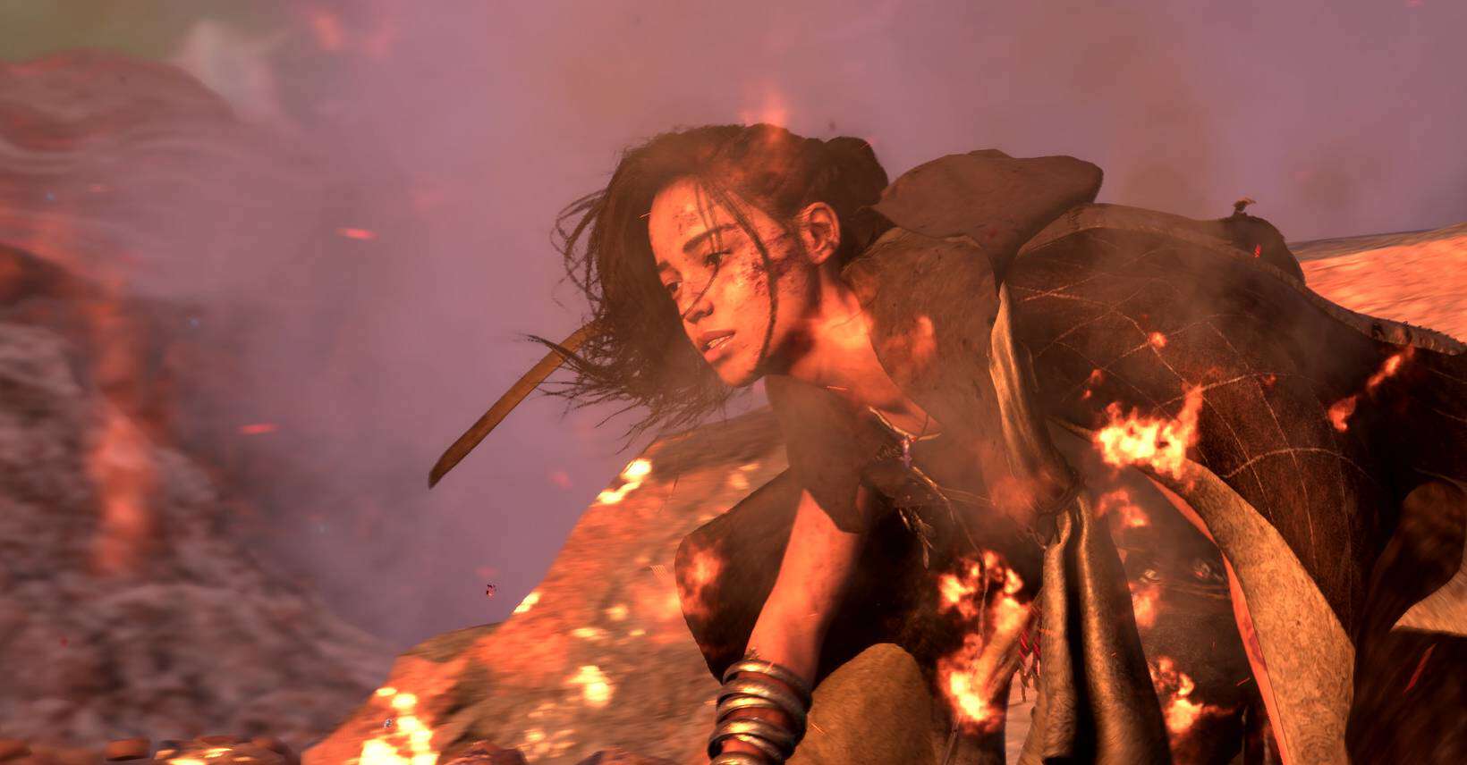 A woman wielding a sword stands confidently in front of a blazing fire, embodying the essence of power and strength.
