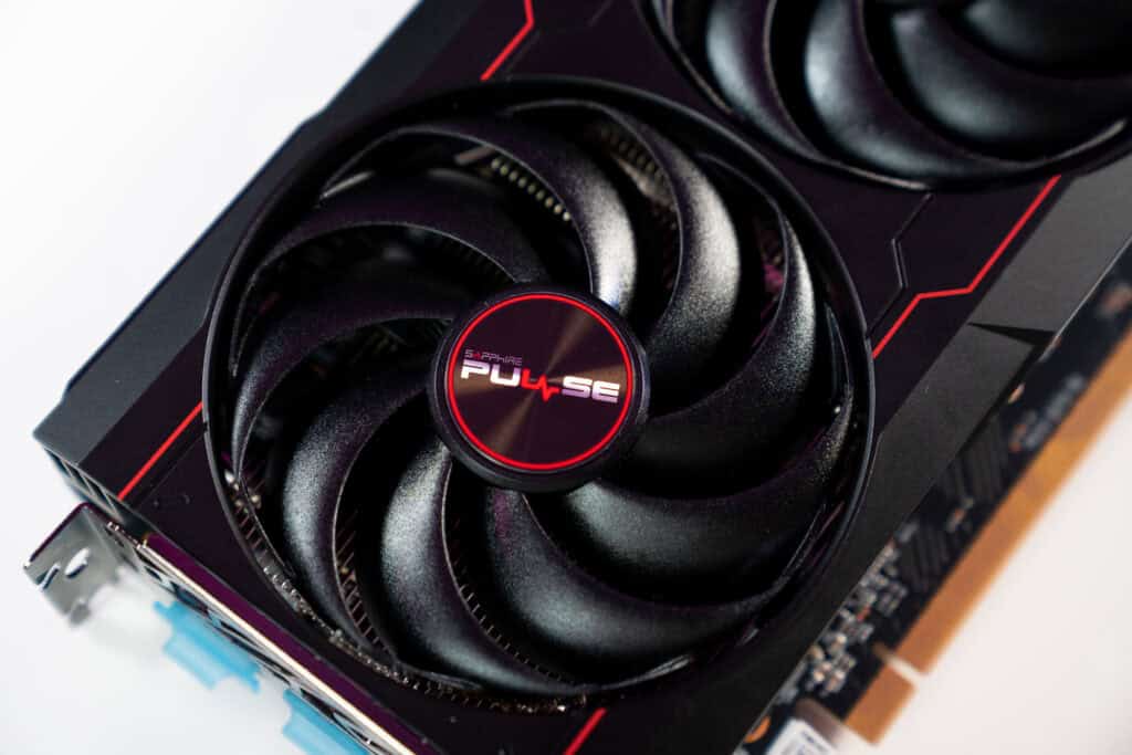 Close-up of a sapphire pulse graphics card showing detailed view of its dual fans and circuit board on a white background, useful for learning how to tell if a GPU is failing.