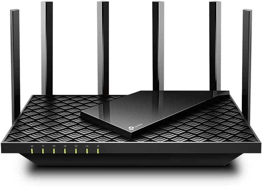 A modern TP-Link AX5400 wireless router with eight external antennas and a textured black surface featuring indicator lights on the front panel.