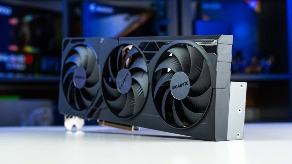 The Gigabyte RTX 4080 Super gigabyte graphics card with triple fans displayed on a white desk.