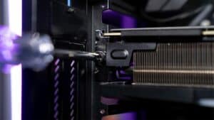 A close up of a computer case with a purple light. Learn how to upgrade a graphics card.