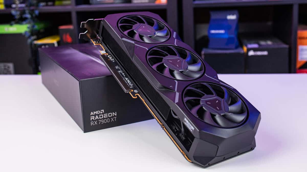 AMD Radeon RX 7900 XT review: A graphics card resting on its box with three cooling fans visible.