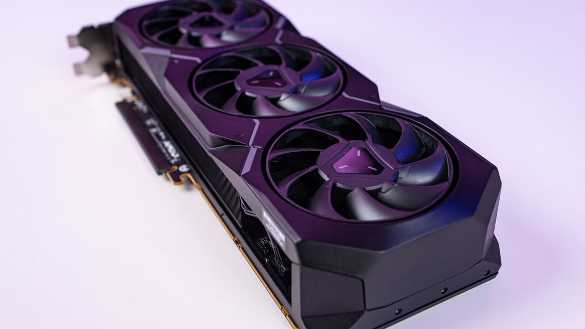 High-performance AMD Radeon RX 7900 XT graphics card with triple fans on a purple background.