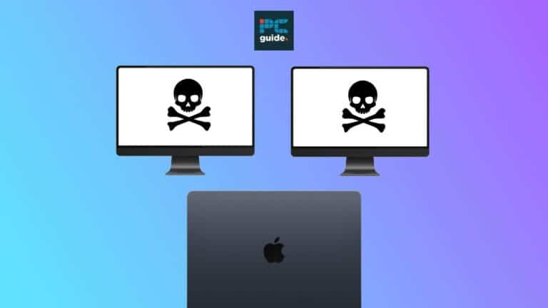 Two computer monitors displaying skull and crossbones symbols, indicating a security threat or piracy, with a MacBook Air M3 in clamshell mode in front.