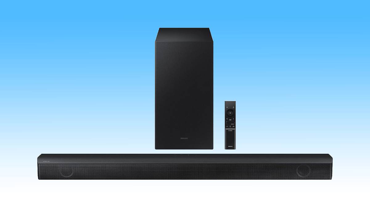 Samsung soundbar with subwoofer and remote control against a blue background.