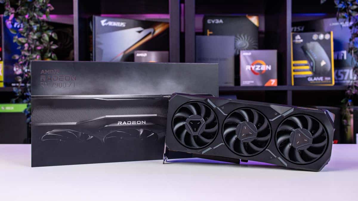 Amd Radeon RX 7900 XT graphics card review, highlighted with its packaging, displayed against a backdrop of computer hardware components.