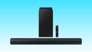 Soundbar with subwoofer and remote control on a blue background to solve woes with your TV speakers.