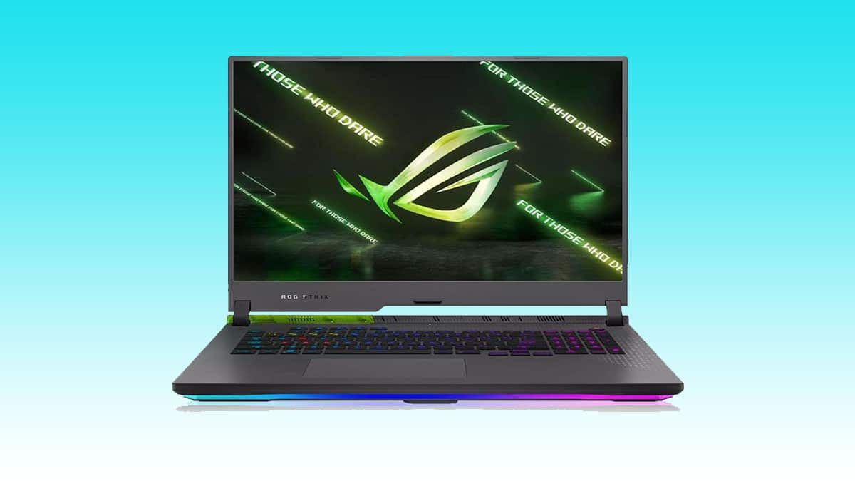 Gaming laptop with RGB lighting showcasing the ASUS ROG logo on the screen.