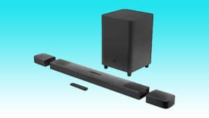 Black soundbar with wireless subwoofer and satellite speakers on a teal background, featuring auto draft technology.