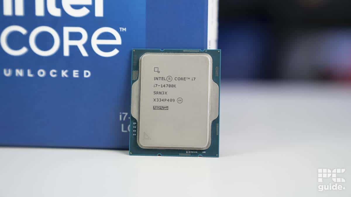 An Intel Core i7-14700K processor displayed in front of its packaging box with an "unlocked" label, ready to go in a machine.