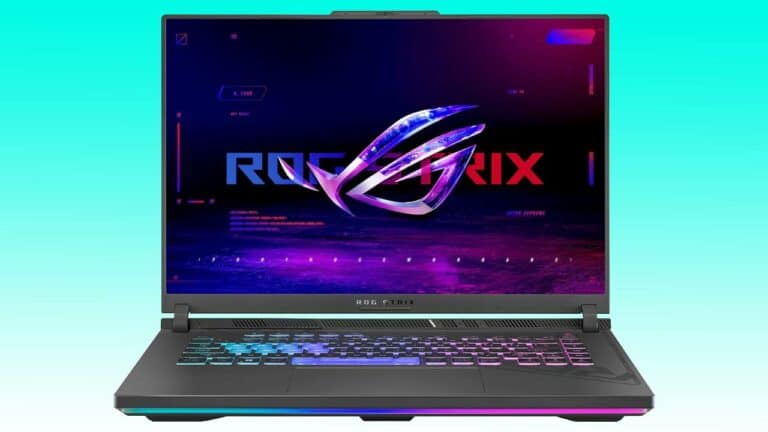 A gaming laptop with an illuminated keyboard and a colorful rog strix logo displayed on the screen, set against an auto draft blue gradient background.