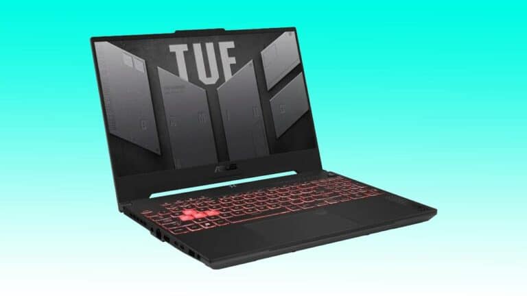An Asus TUF gaming laptop with a black design, backlit red keyboard, and the lid displaying the TUF logo against an auto draft teal background.