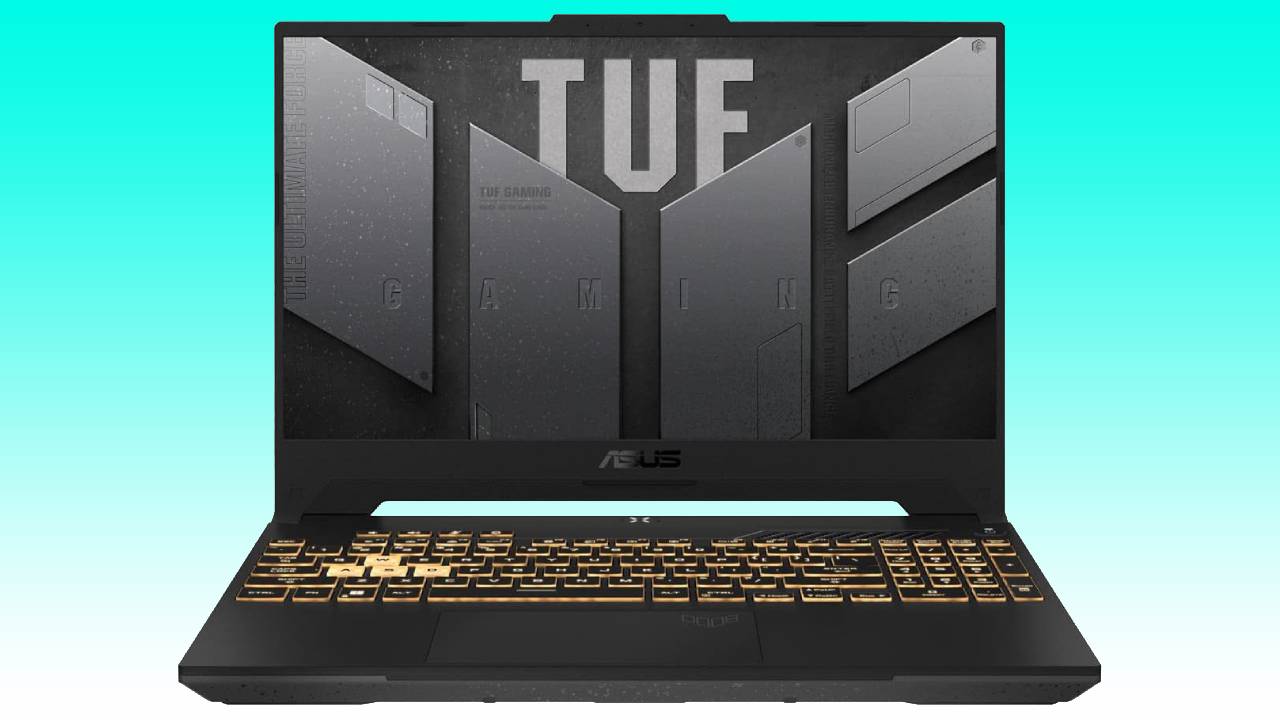 An asus tuf gaming laptop with a black and gold keyboard, the display lid open, showing the auto draft logo on the screen.