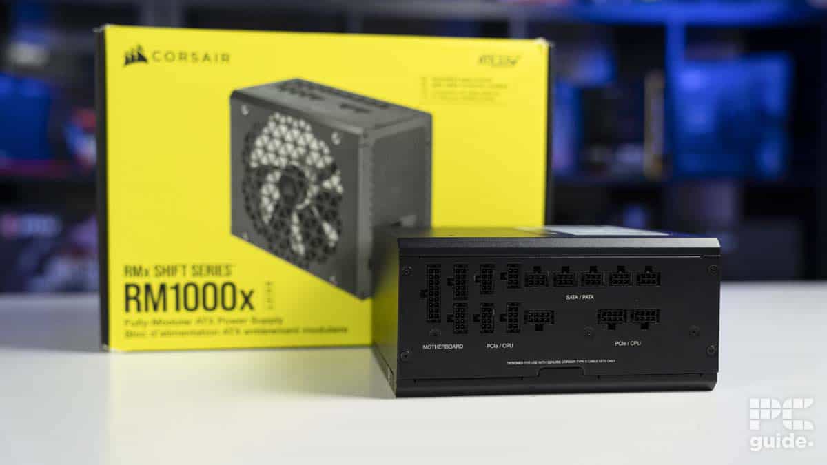 A Corsair RM1000X Shift power supply unit in front of its packaging box.
