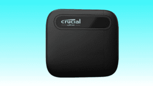 Black Crucial X6 2TB Portable SSD on a blue background.
