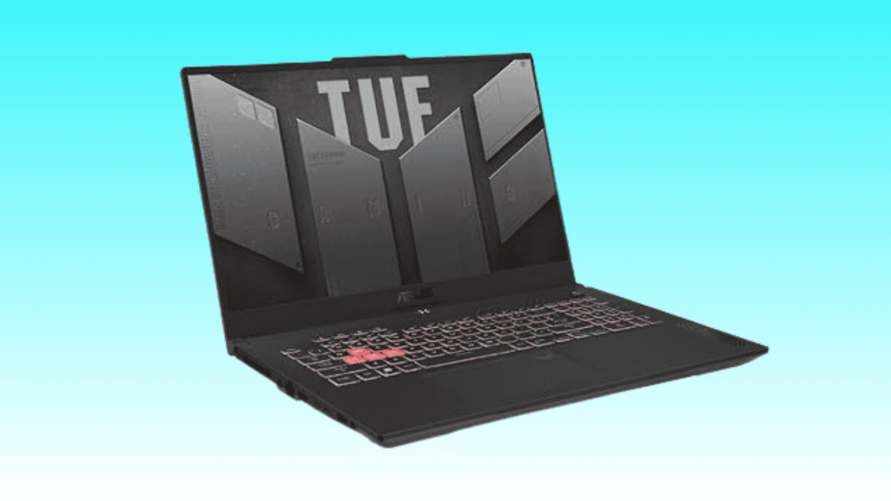 Black ASUS gaming laptop with backlit keyboard on a teal background.