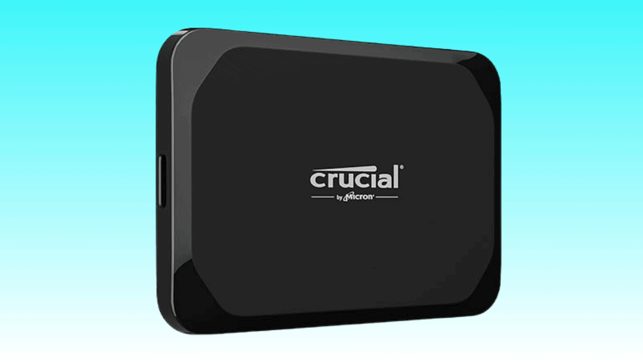 A black Crucial X9 portable SSD against a turquoise background.