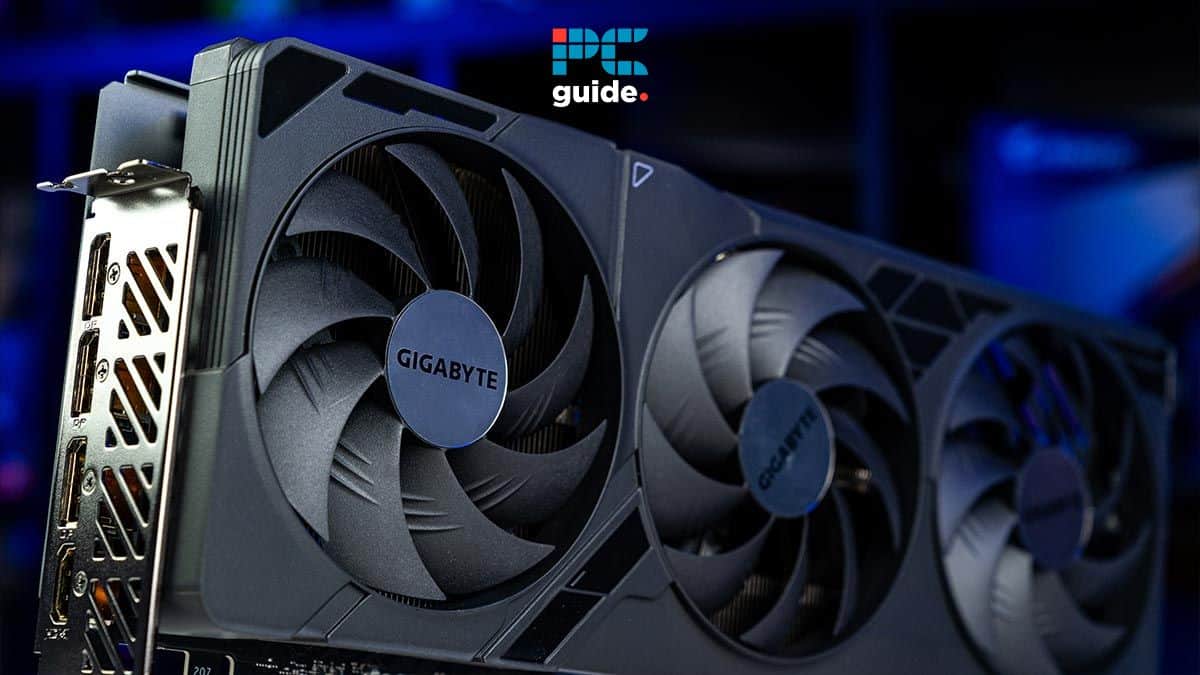 A gigabyte graphics card featuring three fans and a metallic backplate, set against a blurred blue background with PC guide logo, illustrating how to clear GPU memory.