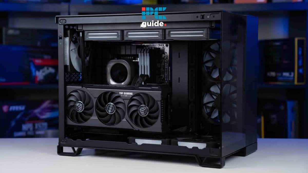 A modern gaming pc with a visible interior, featuring three cooling fans, a vertically mounted GPU, and motherboard, set against a blurred background of electronics.