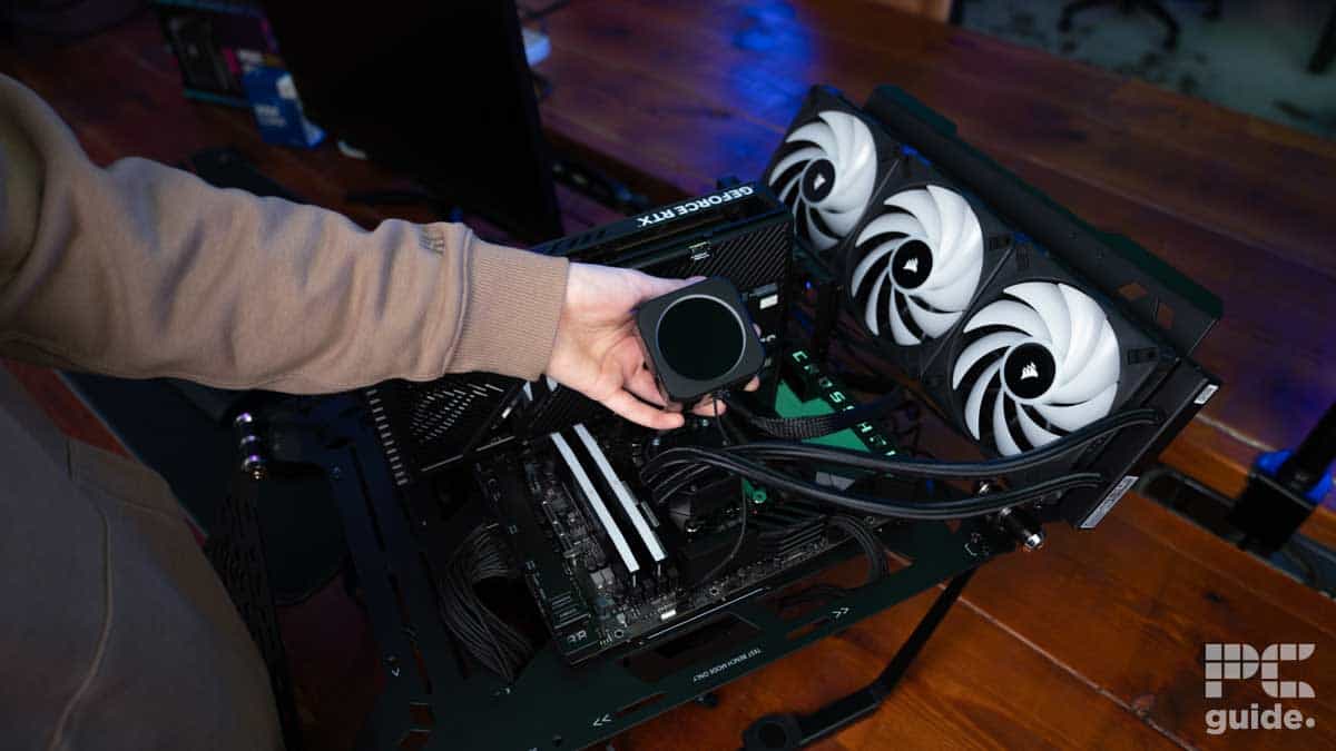Jack Howarth installing the cooling system on our CPU test rig, Image by PC Guide