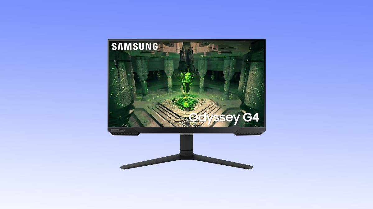Samsung Odyssey G4 gaming monitor deal displaying a vibrant sci-fi game scene, set on a sleek desk against a blue background.