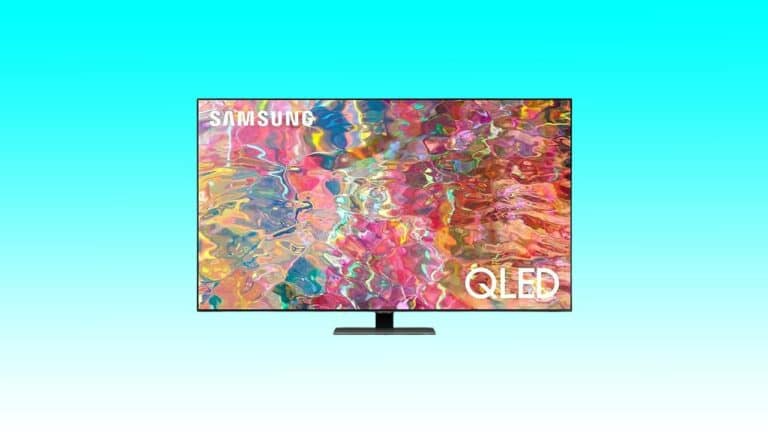 A Samsung QLED 4K TV displaying a vibrant, abstract multicolored image on a plain light blue background.
