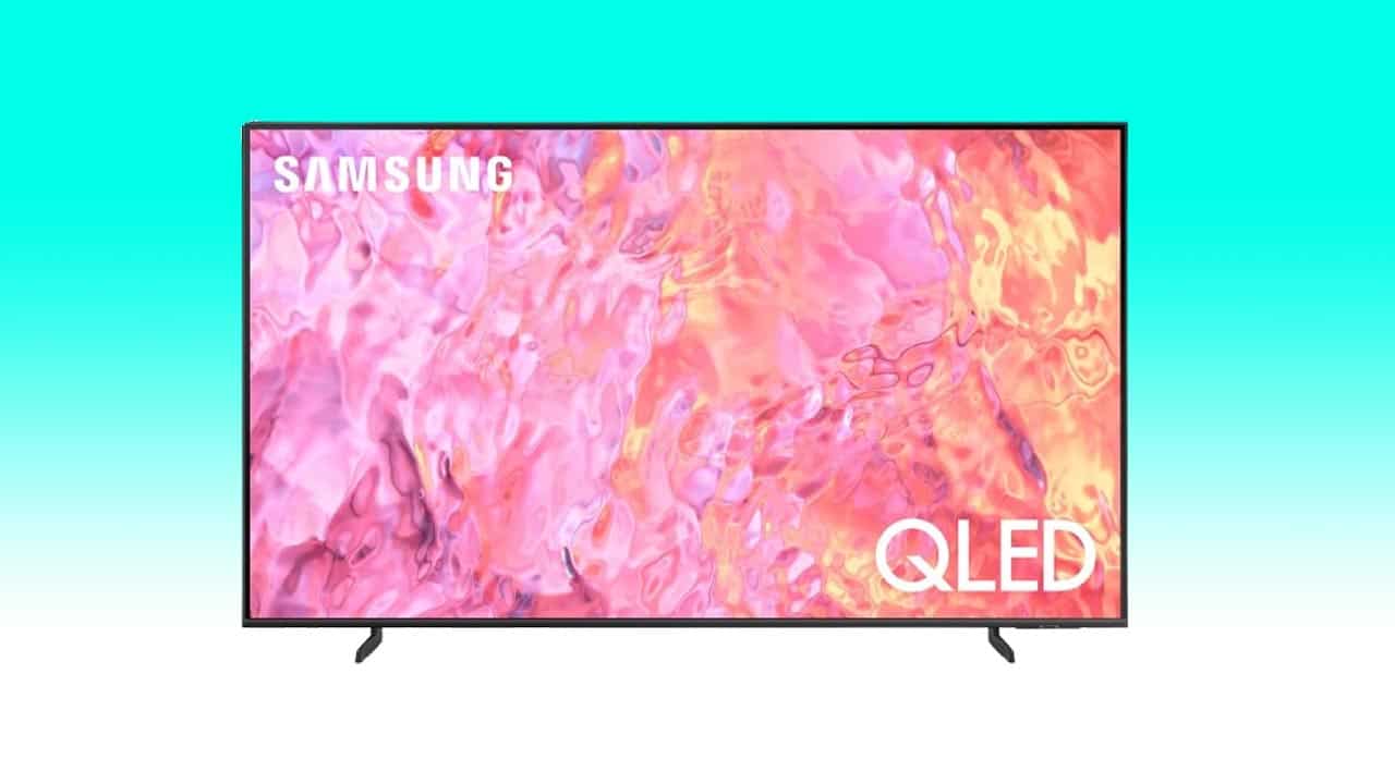 A Samsung QLED 4K TV displaying a vibrant, abstract pink and orange pattern on its screen, isolated against a light blue background.
