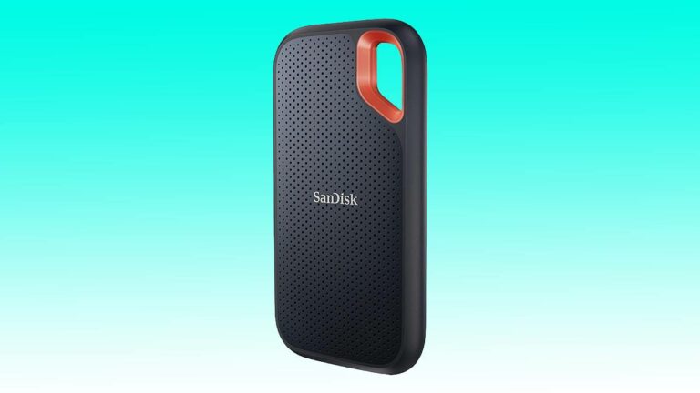 Black sandisk portable ssd with a textured surface and an orange loop on top, displayed against an auto draft blue background.