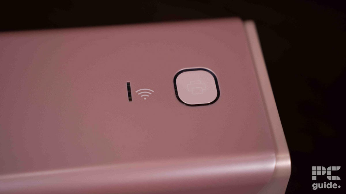 Close-up of a pink Munbyn RW401AP mobile phone showing its camera, flash, and contactless payment symbols.