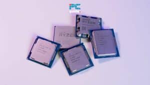 Three amd ryzen computer processors and a pc guide promotional card on a purple surface discussing signs CPU dead. Image taken by PCGuide.com