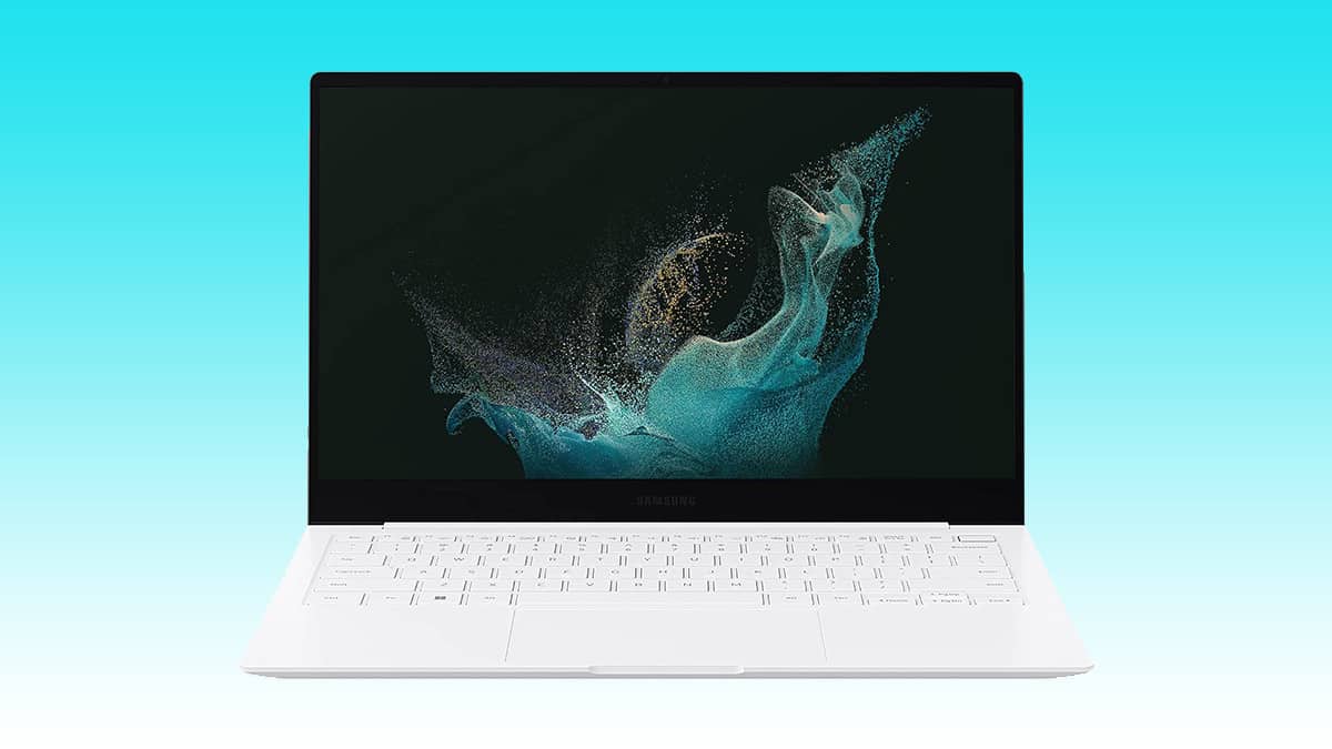 White Samsung Galaxy Book2 Pro laptop on a teal background displaying an abstract wallpaper.