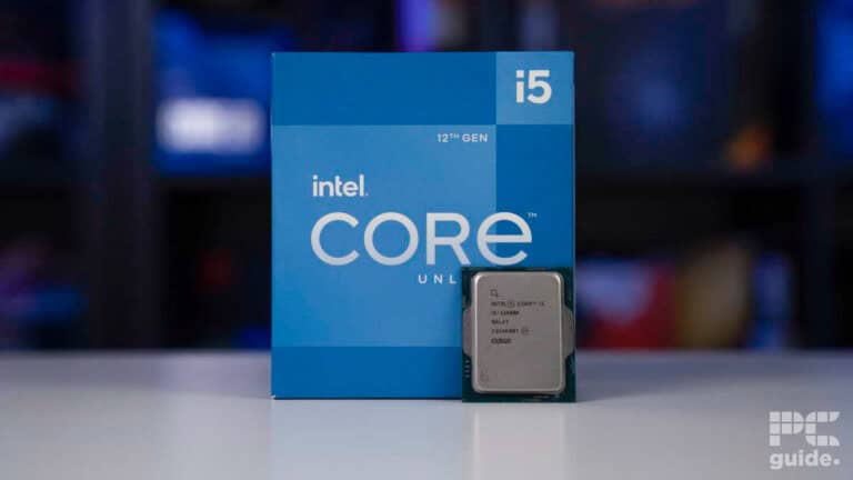An intel core i5-12600K processor beside its blue packaging box on a desk, with a blurred background.
