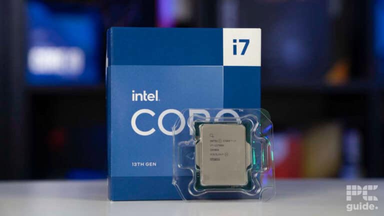An Intel Core i7 13th gen processor in clear packaging placed in front of its blue box with the Intel logo visible, ready for review.