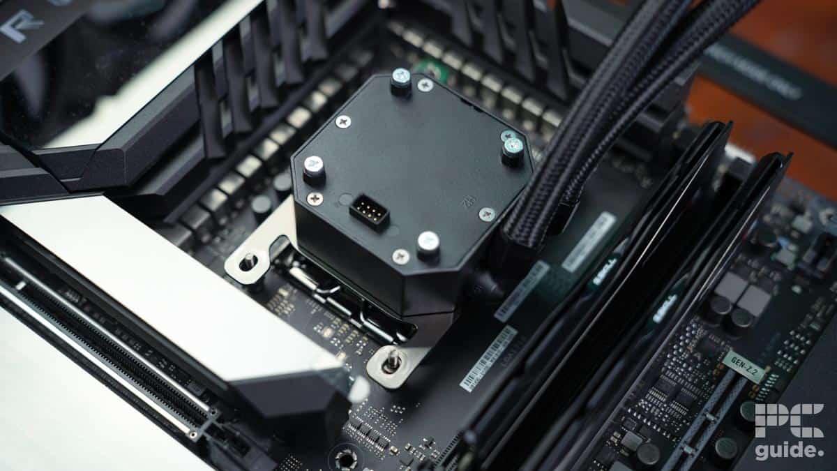 A close-up view of a H150i CPU water block attached to a motherboard inside a computer case, highlighting the detail of computer components and connectivity with an ELITE LCD for precise monitoring.