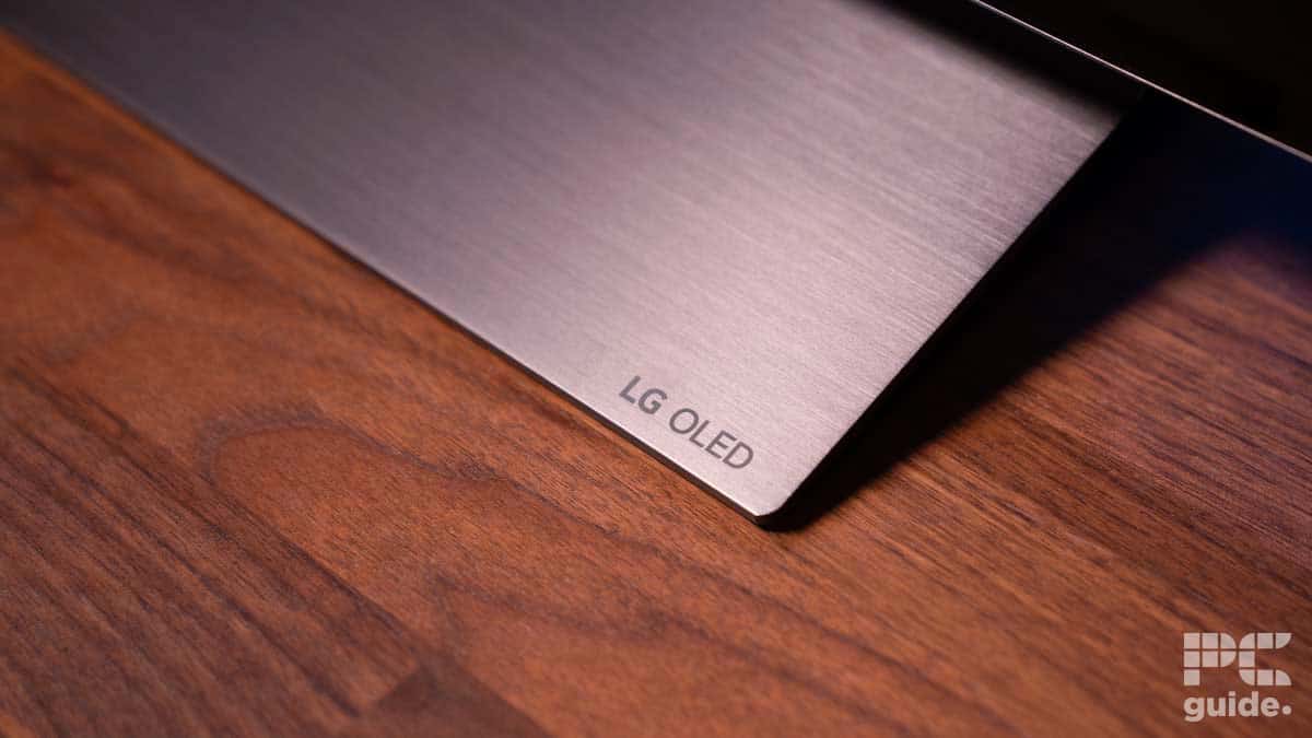 Close-up of the corner of an LG C4 OLED television screen on a wooden surface, with 