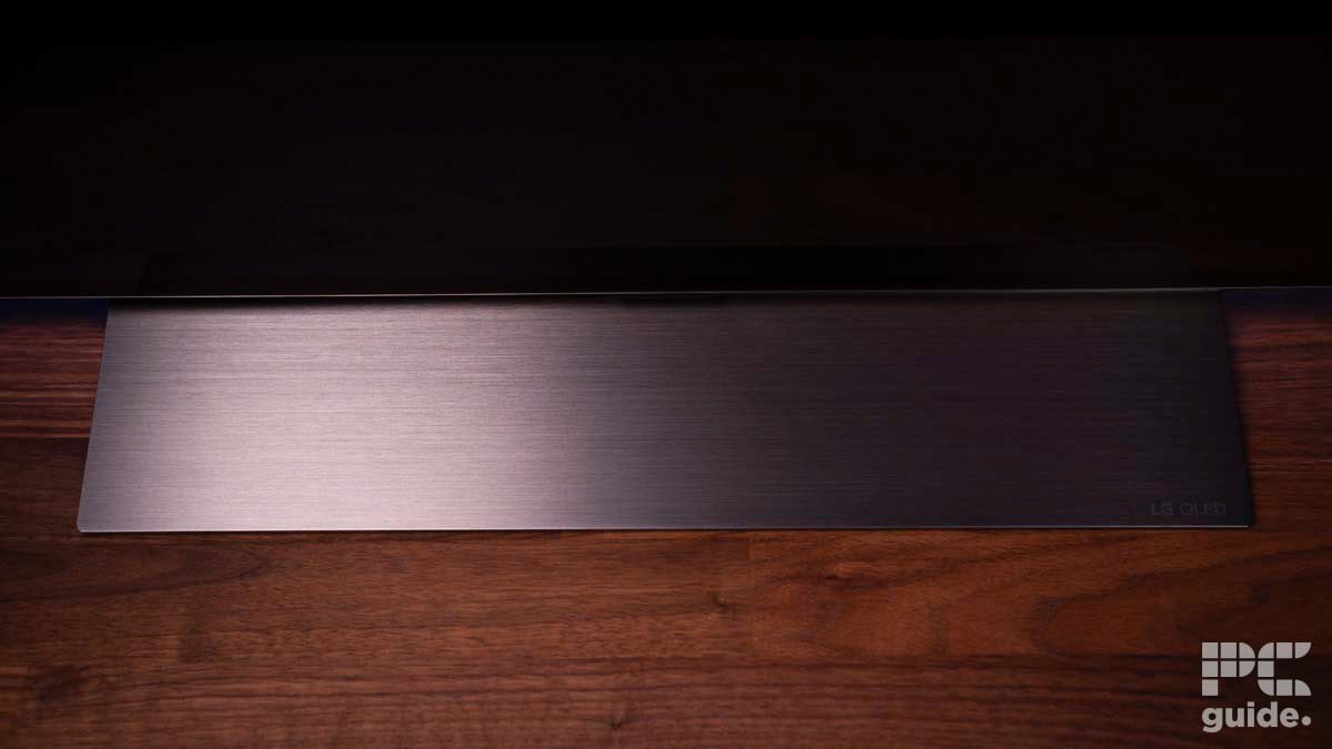 A sleek, dark-colored brushed metal surface with a small 
